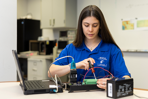A student working with a circuit board in the CRS lab.