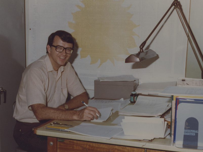 A photo of an instructor in their office, circa 1982