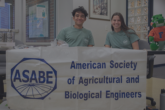 Students at a table for the American Society of Agricultural and Biological Engineers, during ABE's Open House 2022
