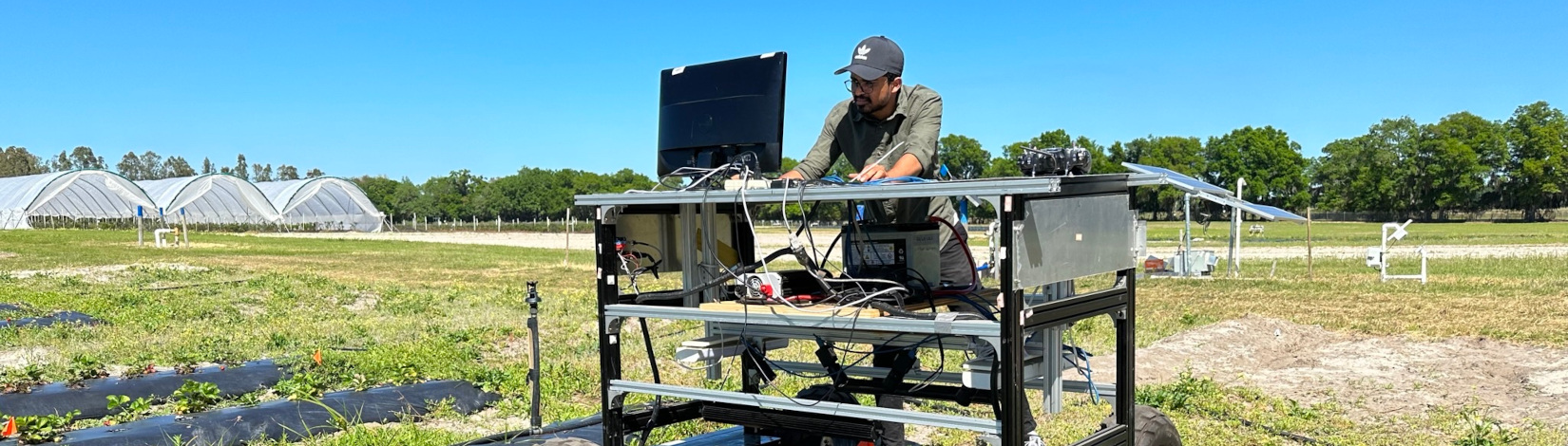 A person using a computer system out on the field.
